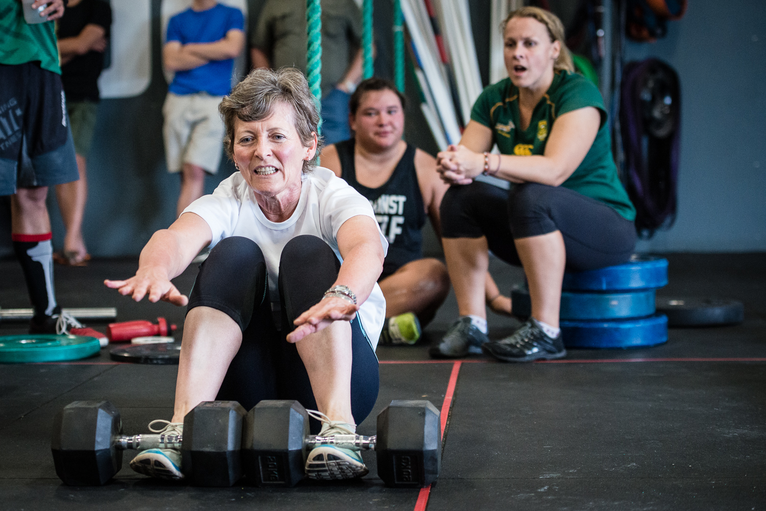 An older woman does sit-ups