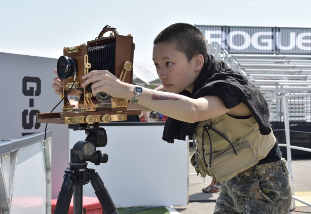 Woman looks into large-format camera