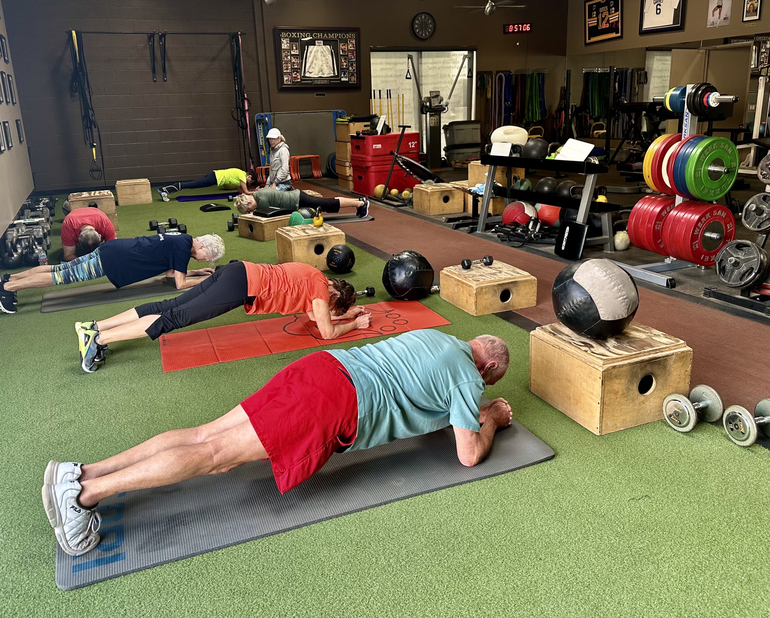 Senior athletes hold planks at Desert CrossFit.