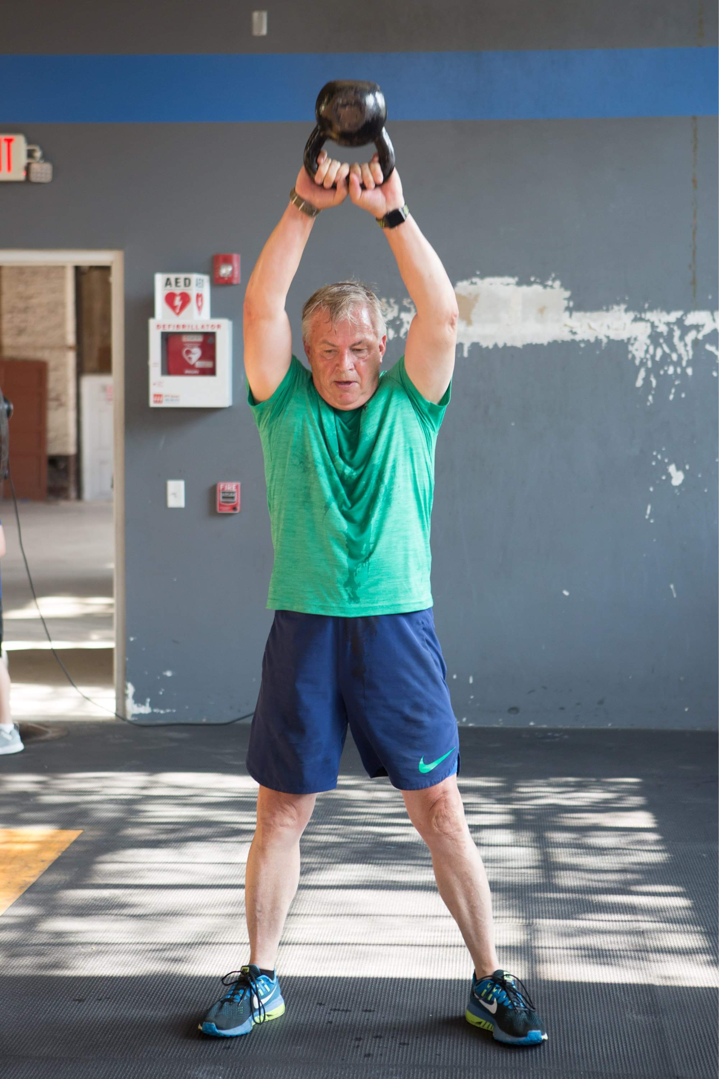 73-year-old Bill Smith does kettlebell swings. 