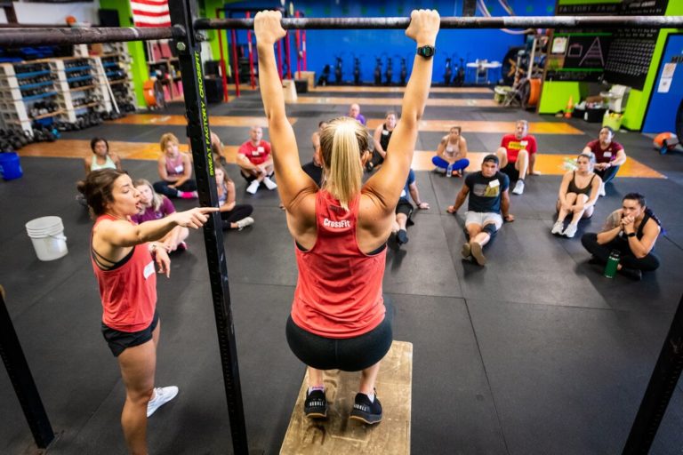 CrossFit coach demonstrating the pull up