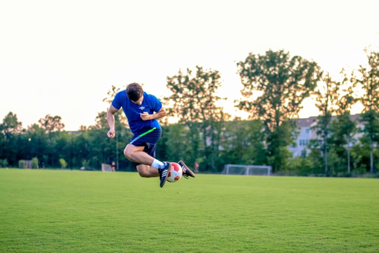 young man doing a soccer trick